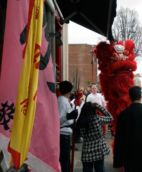As well as his attendants, a huge crowd of onlookers follow the lions through the streets of Chinatown, all to the sound of beating drums and firecrackers popping!