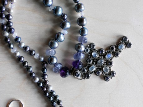 This is another reclaimed pendant, possibly from India. It is silver, inlaid with moonstones and either iolite or amethyst.