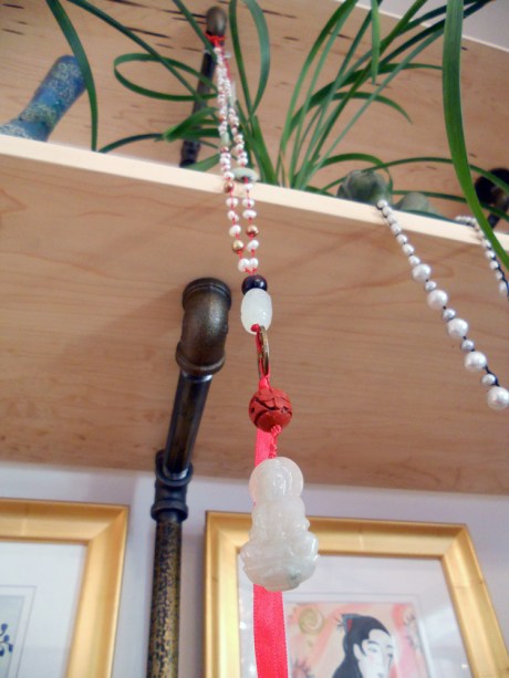 The pale jade Buddha hanging at Arrogant Pirate.