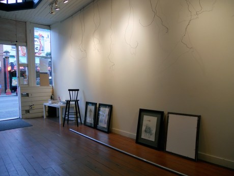 Paintings ready to leave and the wires which held them for the last two weeks. Our beloved neighbourhood of Chinatown can be seen through the open door.