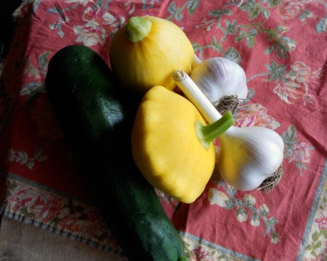 A fresh feast of green zucchini, yellow pattypans and "music" variety garlic.