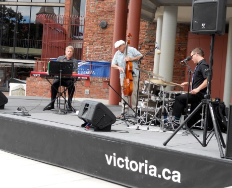 The Damian Graham Trio performing a lunchtime concert as part of the Summer in the Square series. On piano, the wonderful Karel Roessing; the excellent Joey Smith on stand-up bass; and the delightful Damian Graham on drums and vocals: jazz standards, jazzy adaptations and original compositions.